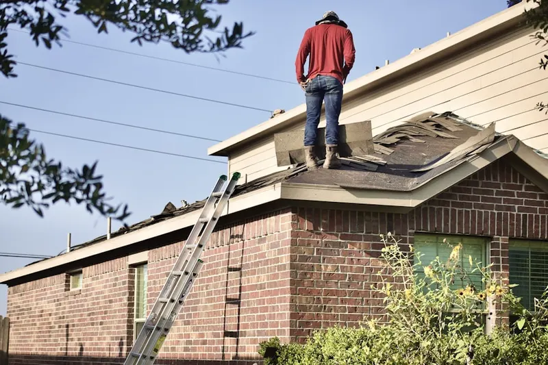 Professional roofer working on a residential roof in Squires Grove